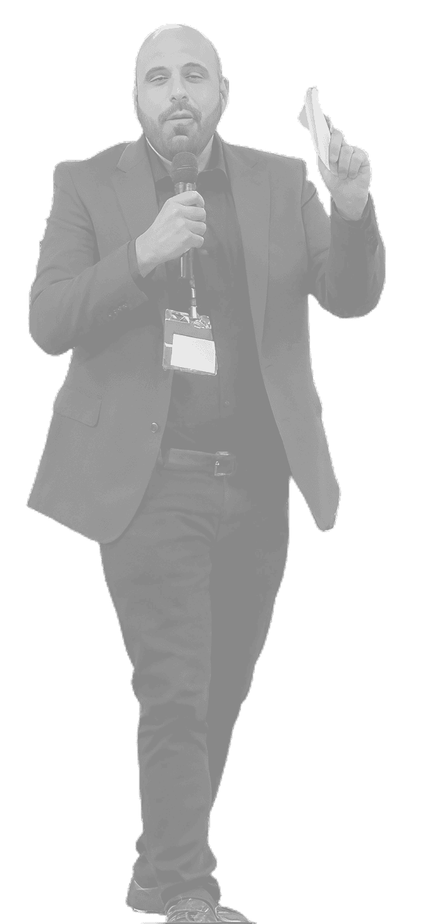 Mike Del Prete speaking to a crowd with a microphone