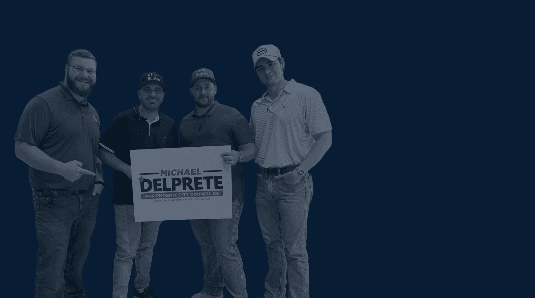 4 men holding up a Mike Del Prete placard